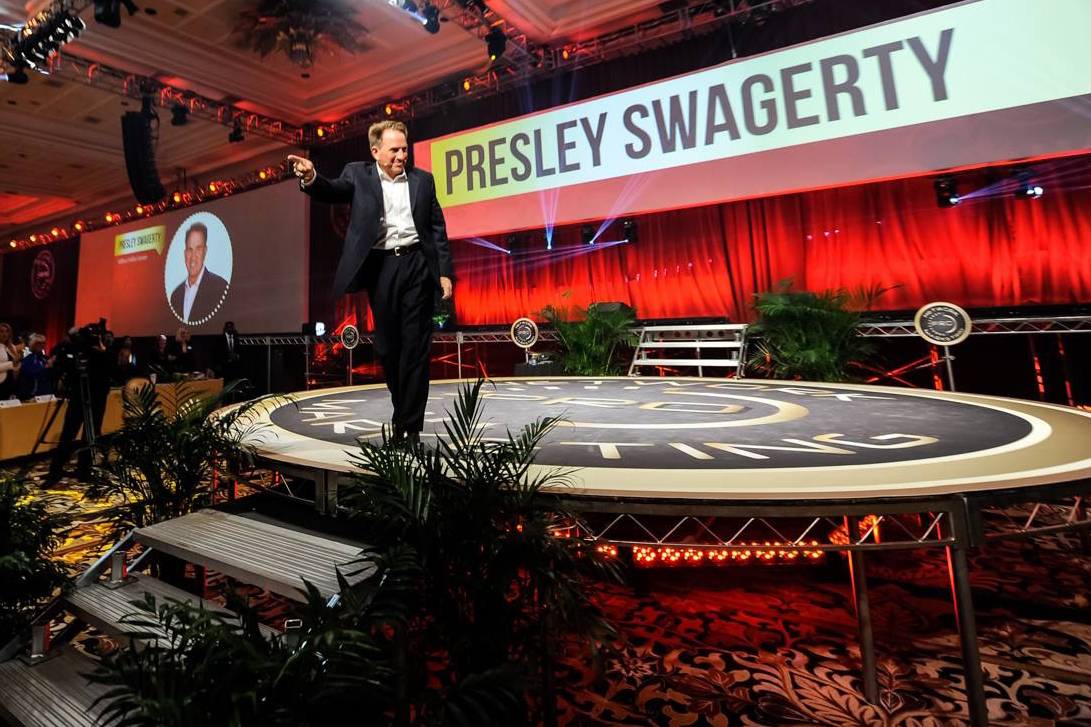 Presley Swagerty speaking at Go Pro Recruiting Mastery on stage with crowd of people