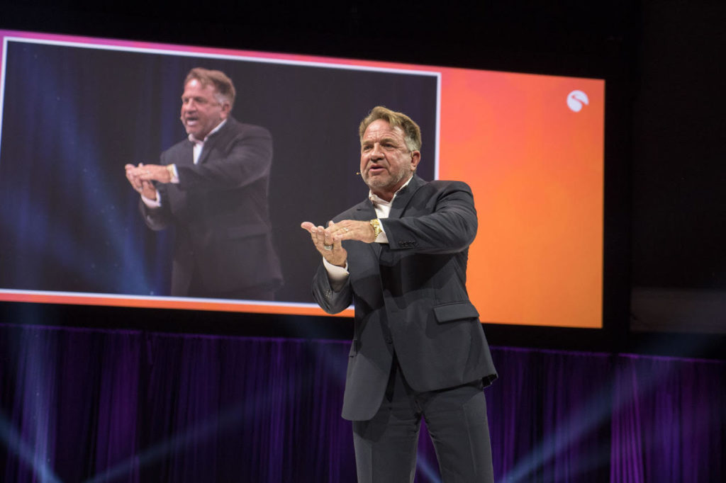 Photo of Presley Swagerty speaking on stage at Stream - Ignition 2018 General Session